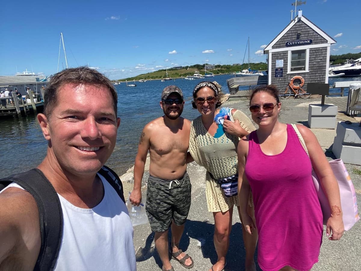 At the Cuttyhunk dock with the CUTTYHUNK sign on the shingled building