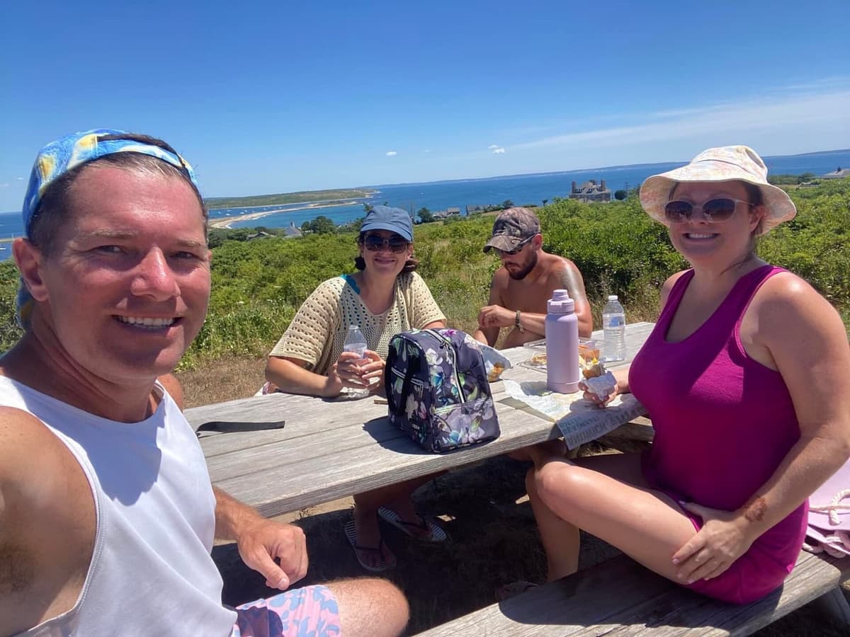 Picnic table at the top of Cuttyhunk with harbor and ocean panorama below