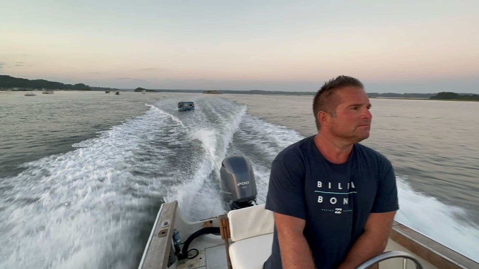 Looking back from the boat, wake behind, open water, sunset